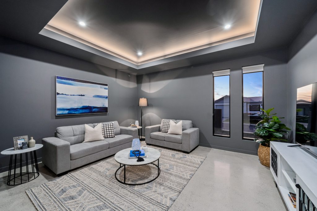 Image shows the interior design of a home built by Benelong Projects. Stone floors and grey walls give a modern look, while tall windows ensure natural light.