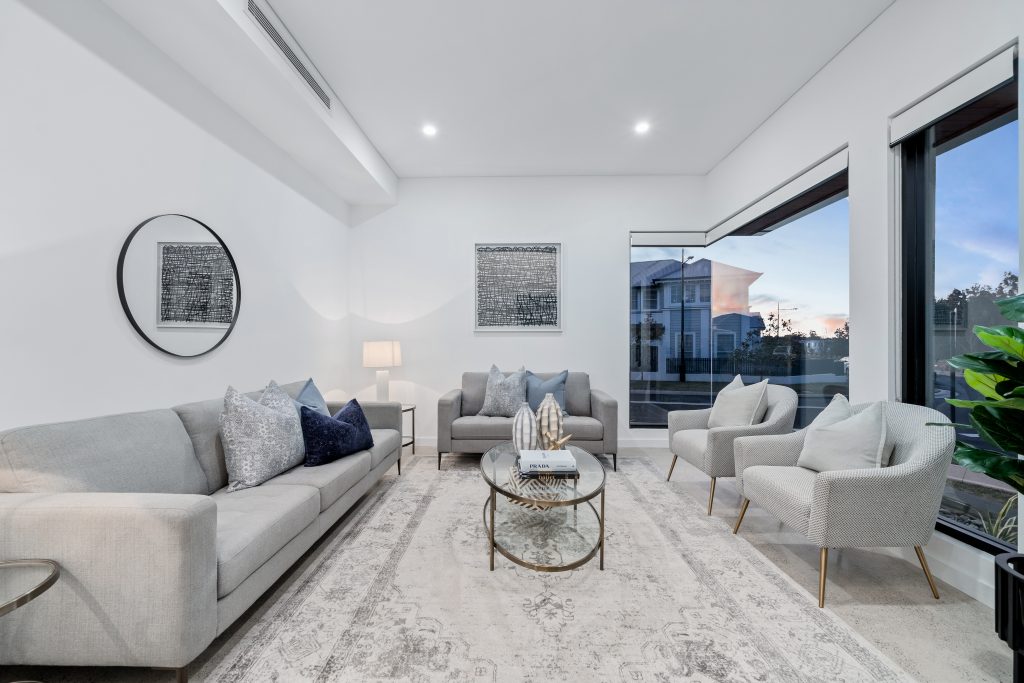 Image shows a home built by Benelong Projects, Sydney based home builders. Large windows ensure maximum natural light while down-lighting and stone floors give a modern look