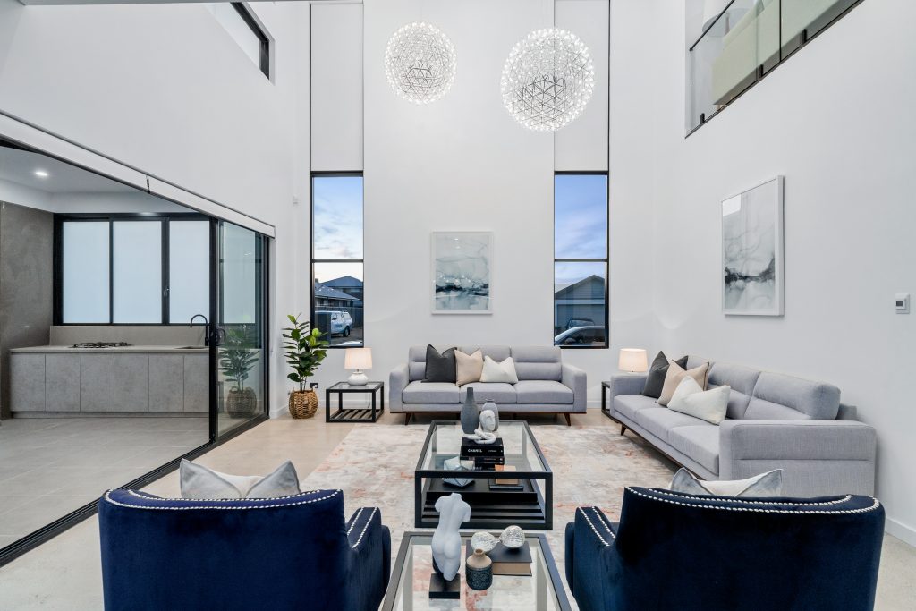 Image shows a stylish modern interior that is well lit with natural lighting. White walls with stone floor