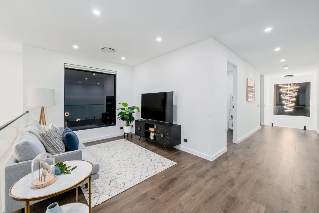 Image shows the interior of a house build by Benelong Projects, Sydney based Home builders. Large windows, led lighting, spacious interior with wooden flooring