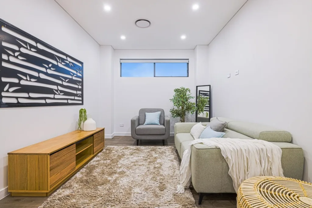 Image shows a spacious and comfortable living area with couches and TV