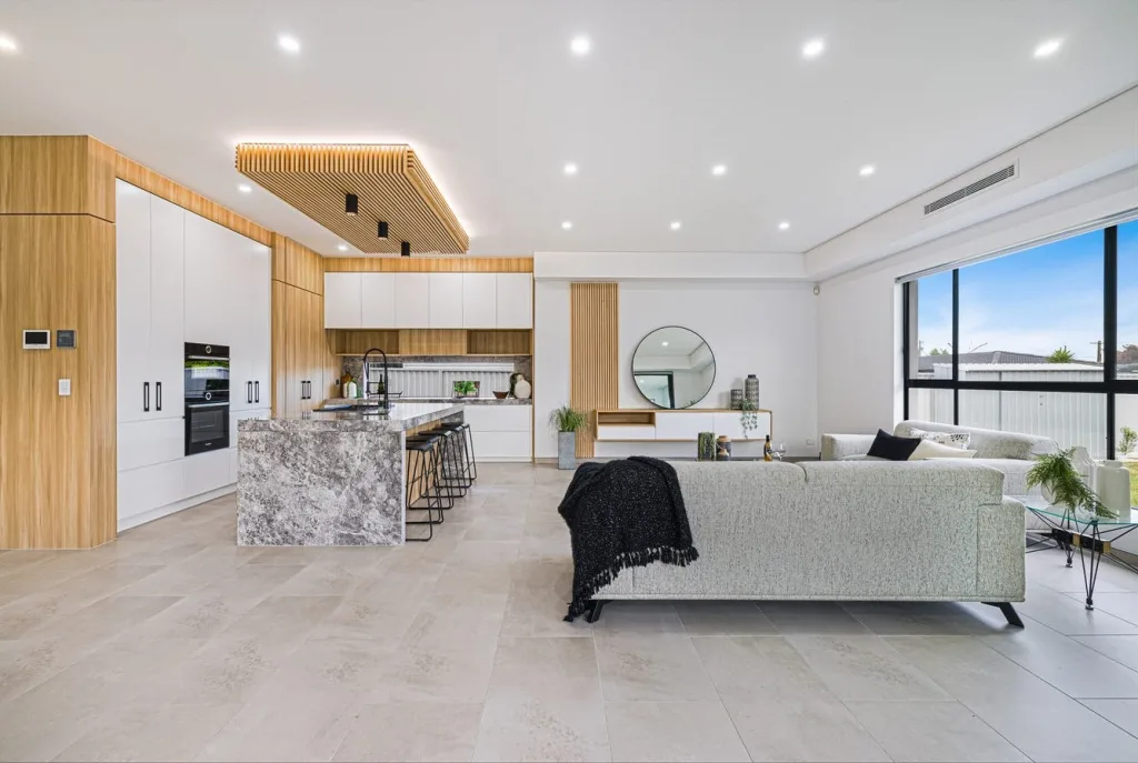 Image shows an open plan kitchen and living area in a Sydney home built by Benelong Projects