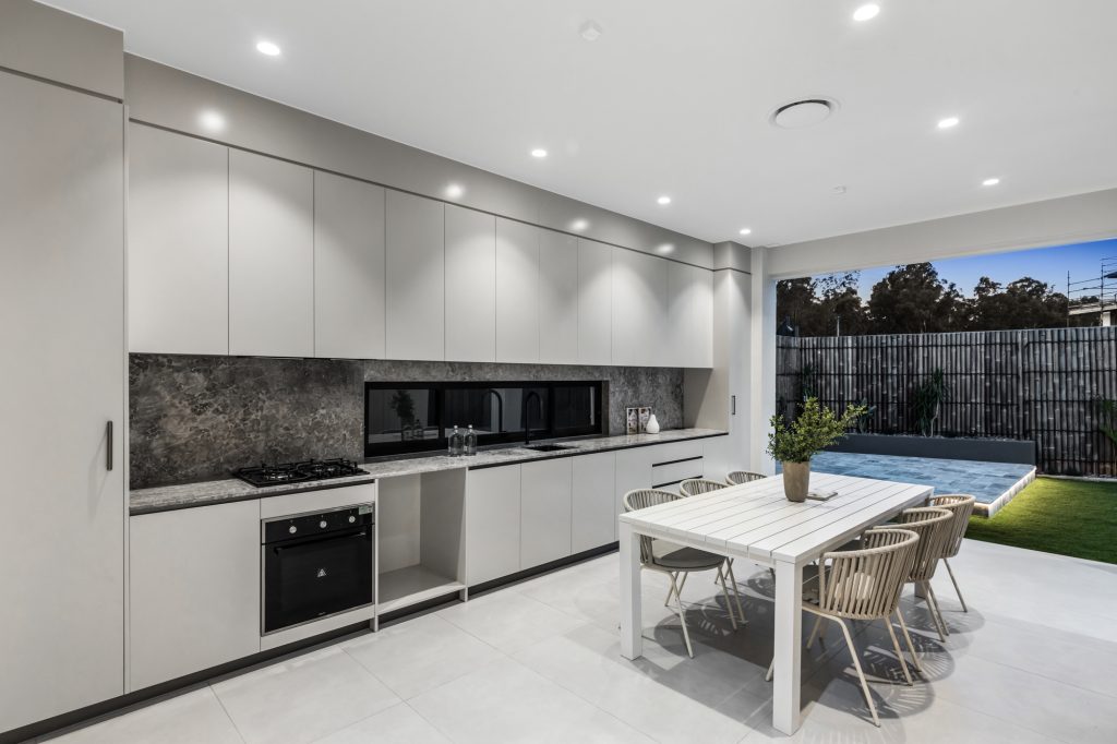 Image shows a spacious open plan kitchen and dining area, backing onto a garden and patio area
