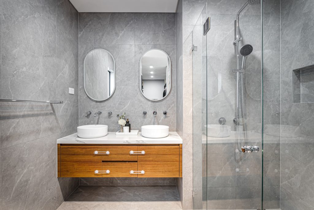 Image shows a Modern spacious Bathroom Design. Benelong projects home build. Granite tiles floor to ceiling with large shower