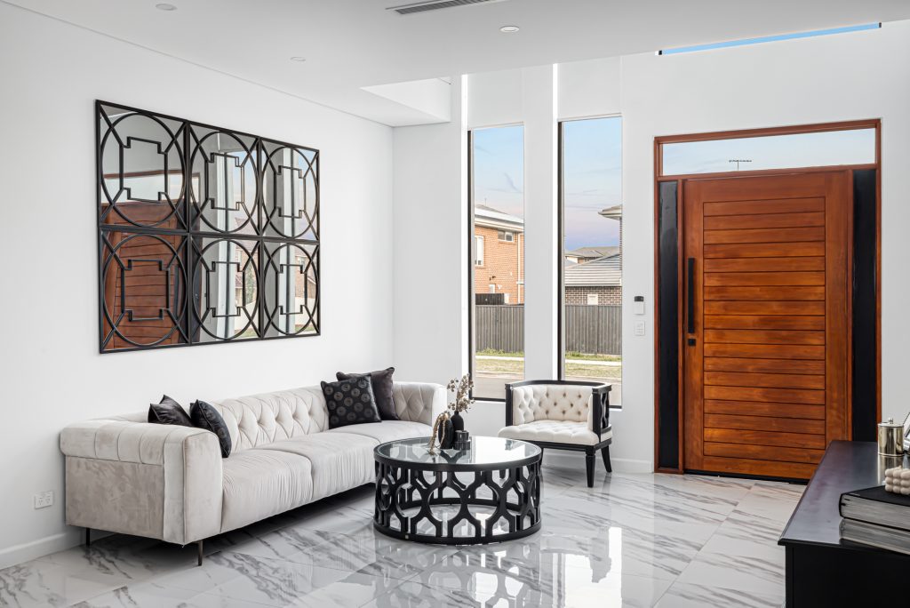 image shows Entrance way / Foyer within Benelong Projects residential home build. Interior design with marble floors and seating