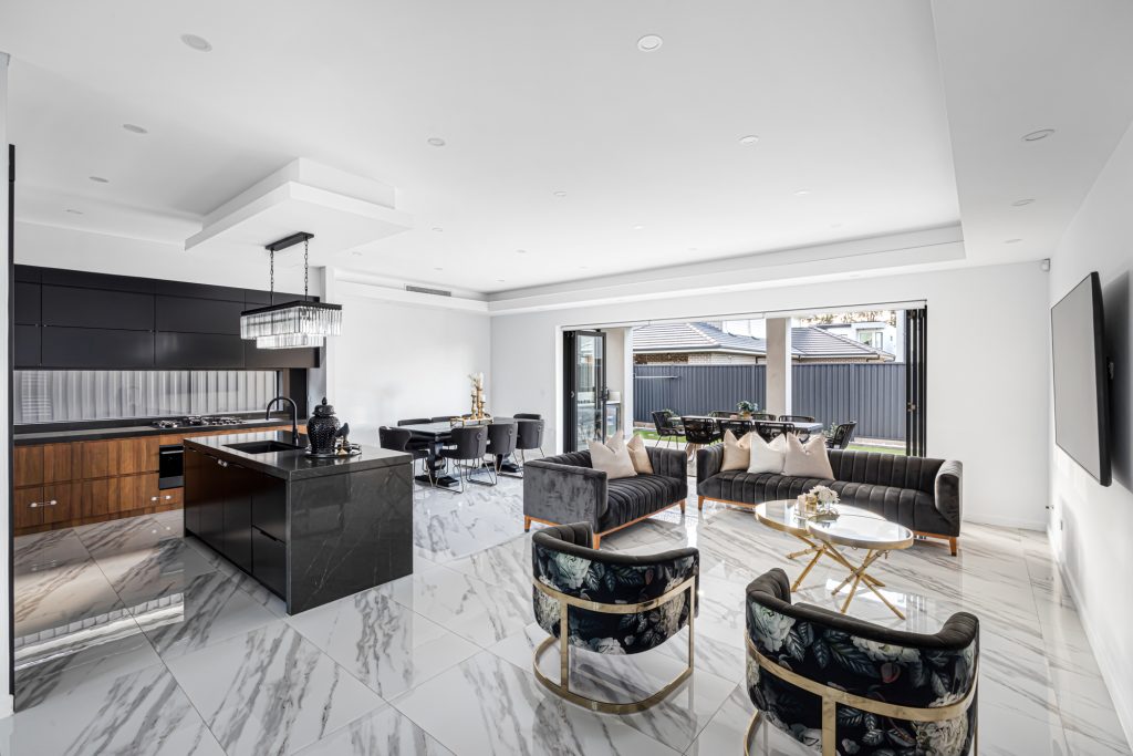 Image shows Open Plan kitchen, dining, and living area. Excellent interior design within Benelong Projects residential home build