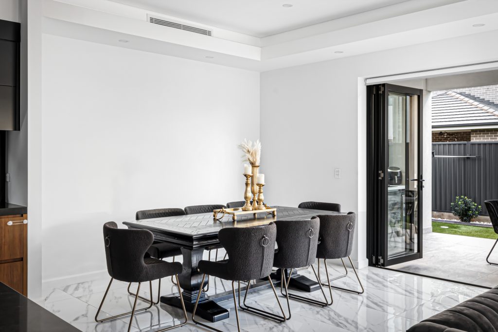 image shows a spacious dining area with Marble floors, complete with table and chairs