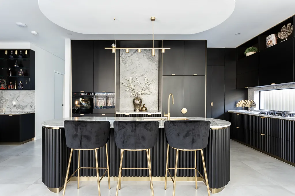 Image shows a breakfast bar with stools, granite bench tops and grey tiled floors