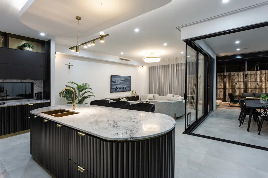 Image shows a home with open plan kitchen and living area