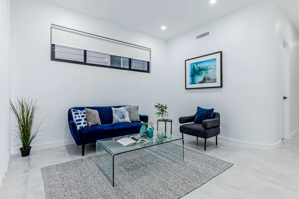 Image shows a second living area with white marble tiles and white walls. Sydney home builders benelong projects
